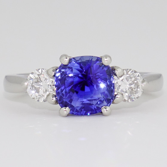 Platinum cushion cut unheated sapphire and diamond three stone ring