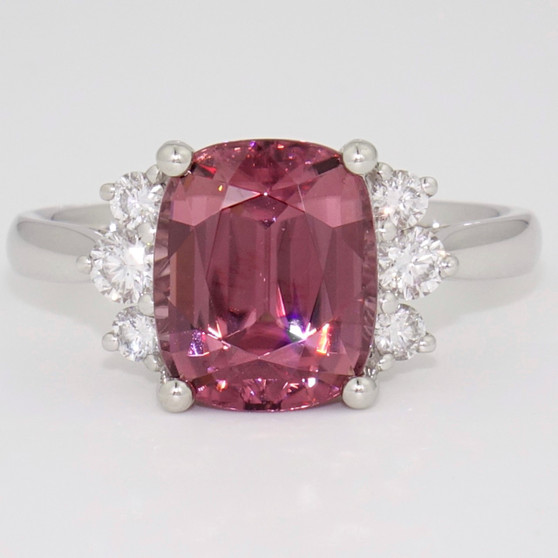 Unique platinum cushion cut pink zircon and graduated round brilliant cut diamond ring