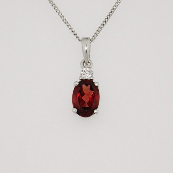 9ct white gold oval cut garnet and diamond pendant