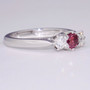 18ct white gold diamond trilogy ring with treated fancy vivid purplish pink centre diamond