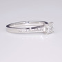 Platinum princess cut diamond solitaire ring with diamond-set shoulders