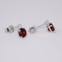9ct white gold round cut garnet and round brilliant cut diamond stud earrings side