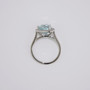 Platinum trillion cut aquamarine and diamond cluster ring with diamond-set shoulders top