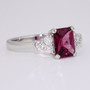 Platinum scissor cut raspberry garnet and round brilliant cut diamond ring side