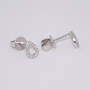 Platinum round brilliant cut diamond open pear shaped stud earrings side