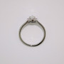 Platinum pear cut diamond halo ring with diamond-set shoulders and milgrain edge top