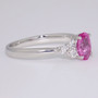 Platinum oval cut pink sapphire and round brilliant cut diamond ring side