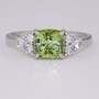Platinum cushion cut green tourmaline and round brilliant cut diamond ring