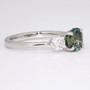 Platinum round cut green sapphire and round brilliant cut diamond ring side