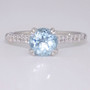 Platinum round cut aquamarine ring with diamond shoulders