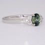 9ct white gold oval cut teal sapphire and round brilliant cut diamond ring side