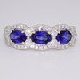 Platinum oval cut sapphire and round brilliant cut diamond triple cluster ring