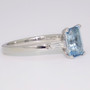 Platinum emerald cut aquamarine and tapered baguette cut diamond ring side