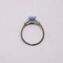Platinum emerald cut aquamarine and tapered baguette cut diamond ring top