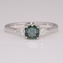 Platinum cushion cut teal sapphire and pear cut diamond ring