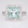 Unique platinum radiant cut unheated aquamarine and diamond halo ring