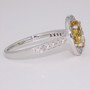 Platinum oval cut Imperial topaz and diamond halo ring with diamond-set shoulders side