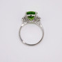 Platinum oval cut peridot and graduated round brilliant cut diamond ring top