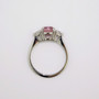 Platinum oval cut padparadscha sapphire and round brilliant cut diamond ring top