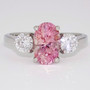 Platinum certificated unheated oval cut padparadscha sapphire and round brilliant cut diamond ring