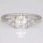 Platinum ring with an asscher cut diamond set with six round brilliant cut diamonds