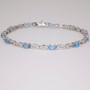 9ct white gold oval cut blue topaz and diamond-set figure-of-eight link bracelet