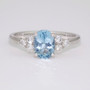 Platinum oval cut aquamarine and six round brilliant cut diamond ring