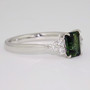 Platinum ring with unheated emerald cut Australian teal sapphire and six round brilliant cut diamonds side