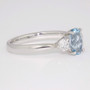 Platinum oval cut aquamarine and round brilliant cut diamond ring side