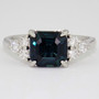 Platinum emerald cut Madagascan teal sapphire and round brilliant cut diamond ring