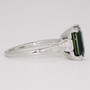 Platinum emerald cut teal sapphire and tapered baguette diamond ring side