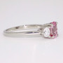 Platinum unheated oval cut padparadscha sapphire and round brilliant cut diamond ring side