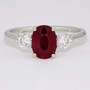Platinum oval cut ruby and round brilliant cut diamond ring