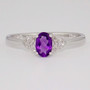 9ct white gold ring with oval cut amethyst and diamond-set V-shaped shoulders