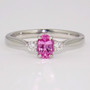 Platinum oval cut unheated pink sapphire and round brilliant cut diamond ring
