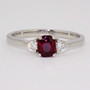 Platinum cushion cut ruby and round brilliant cut diamond ring