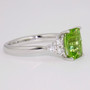 Platinum unheated cushion cut peridot and round brilliant cut diamond ring side