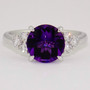 Platinum fancy round cut deep purple amethyst ring with six round brilliant cut diamonds