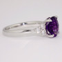 Platinum fancy round cut deep purple amethyst ring with six round brilliant cut diamonds side
