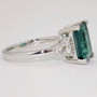 Platinum emerald cut indicolite tourmaline and round brilliant cut diamond ring side