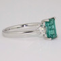 Platinum emerald cut tourmaline and round brilliant cut diamond ring side