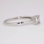 Platinum oval cut white sapphire and round brilliant cut diamond twist ring side