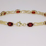 9ct gold oval cut garnet and figure-of-eight link bracelet clasp