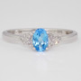 9ct white gold ring with oval cut blue topaz and diamond-set V-shaped shoulders