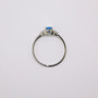 9ct white gold ring with oval cut blue topaz and diamond-set V-shaped shoulders top