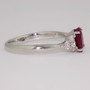 Platinum oval cut ruby and round brilliant cut diamond ring side