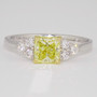 Platinum and 18ct gold certificated radiant cut fancy yellow diamond ring with six round brilliant cut diamonds
