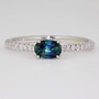 9ct white gold oval cut teal sapphire ring with diamond-set shoulders