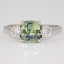 Platinum unheated cushion cut green sapphire and round brilliant cut diamond ring