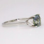 Platinum unheated cushion cut green sapphire and round brilliant cut diamond ring side